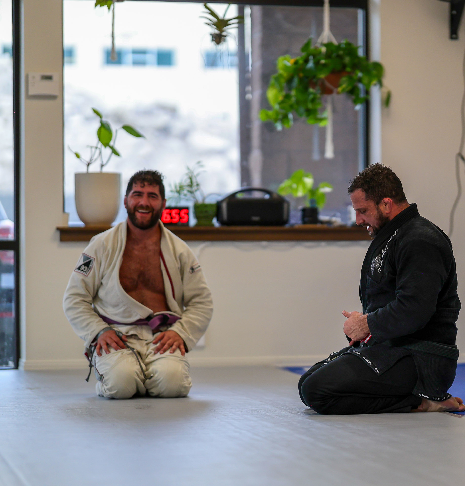 Two members laughing between rounds at Golden Jiu Jitsu