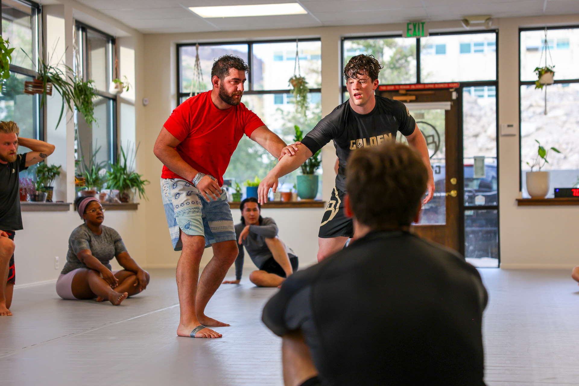 No-gi standup grappling demonstration with class watching at Golden Jiu Jitsu