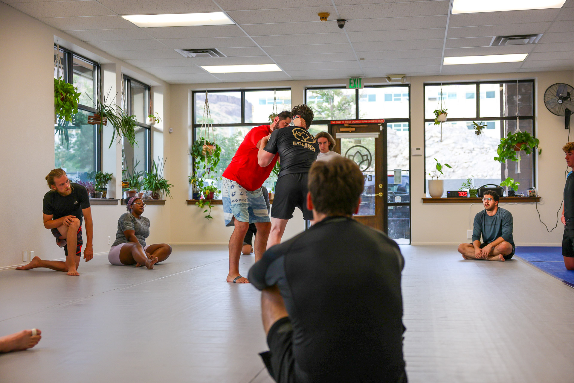 Coach demonstrating a technique while class watches at Golden Jiu Jitsu