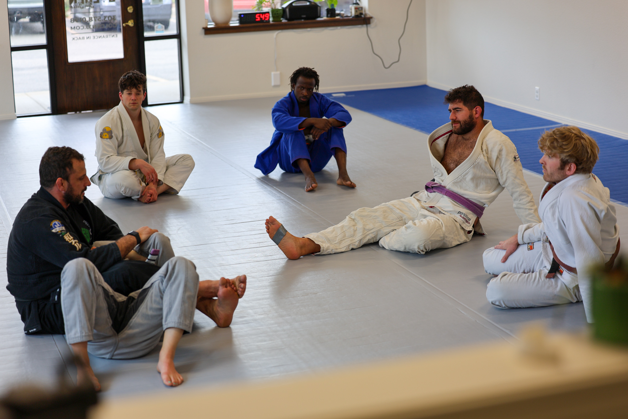 Class seated in a circle during instruction at Golden Jiu Jitsu