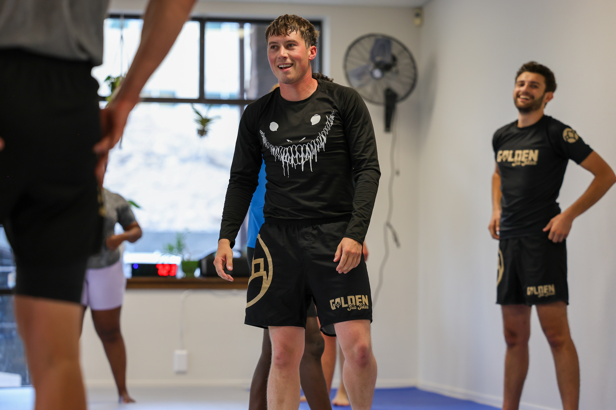 Members laughing together after training at Golden Jiu Jitsu