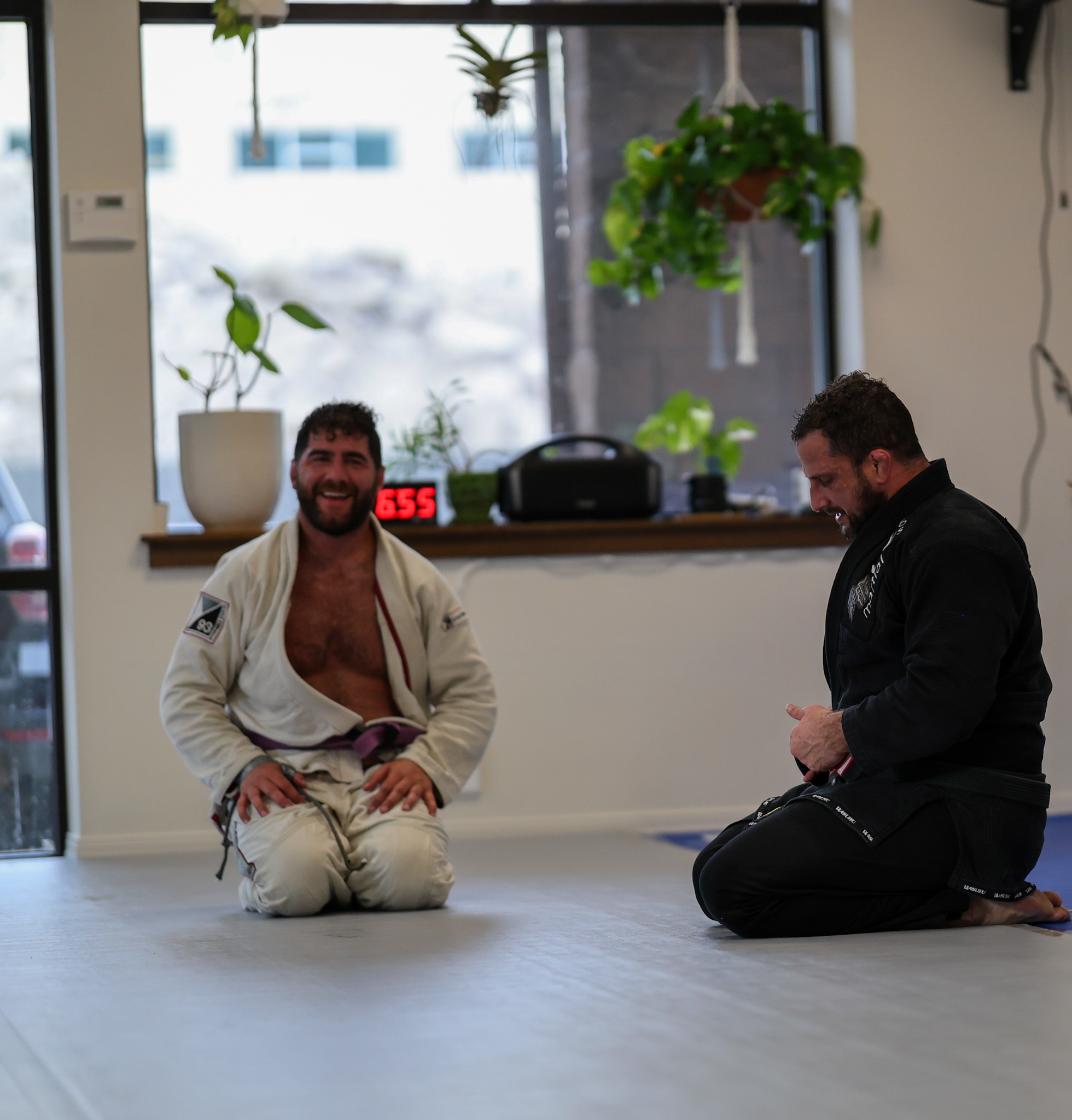 Members smiling together after a training round at Golden Jiu Jitsu