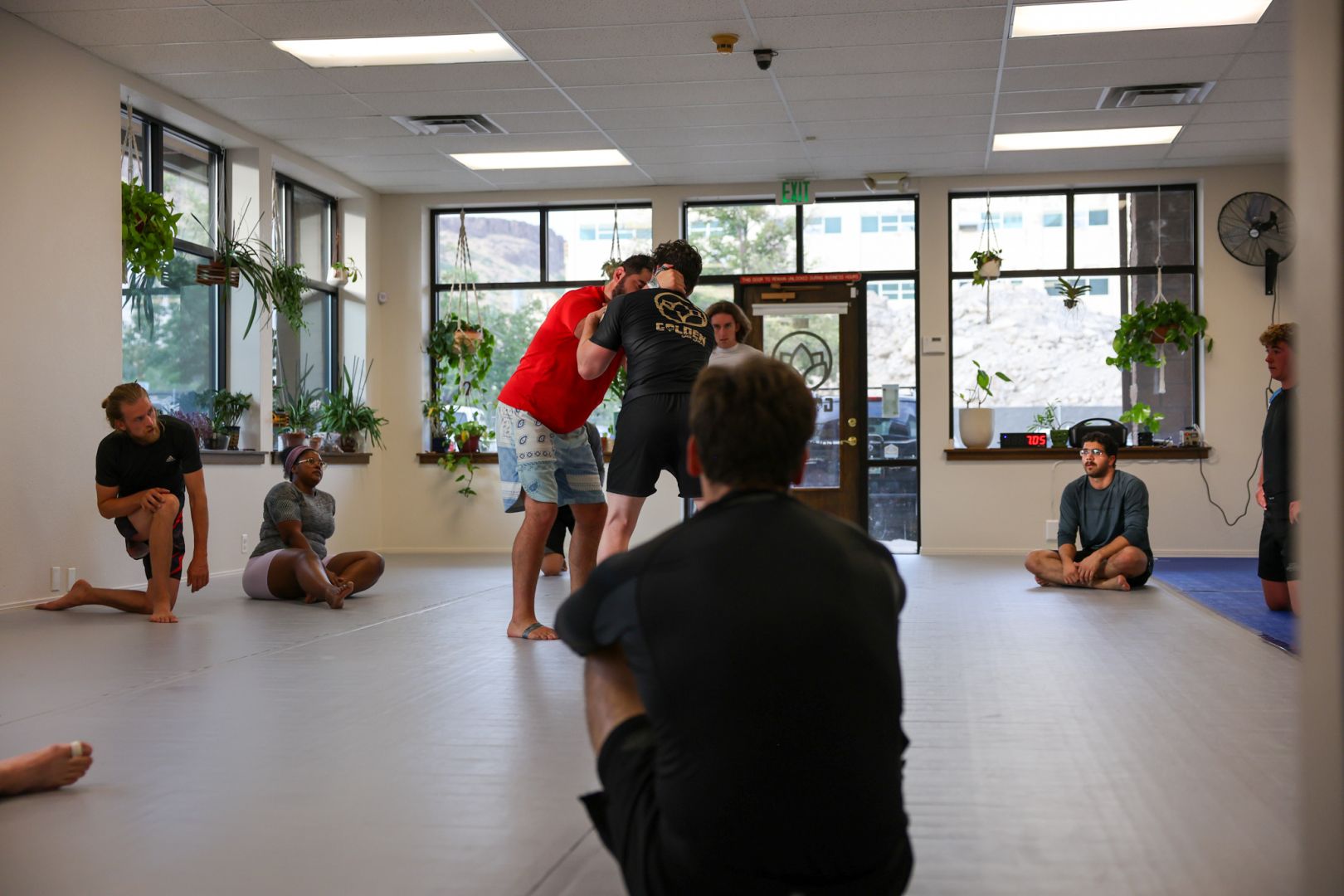 Fundamentals class at Golden Jiu Jitsu with members training standing grappling