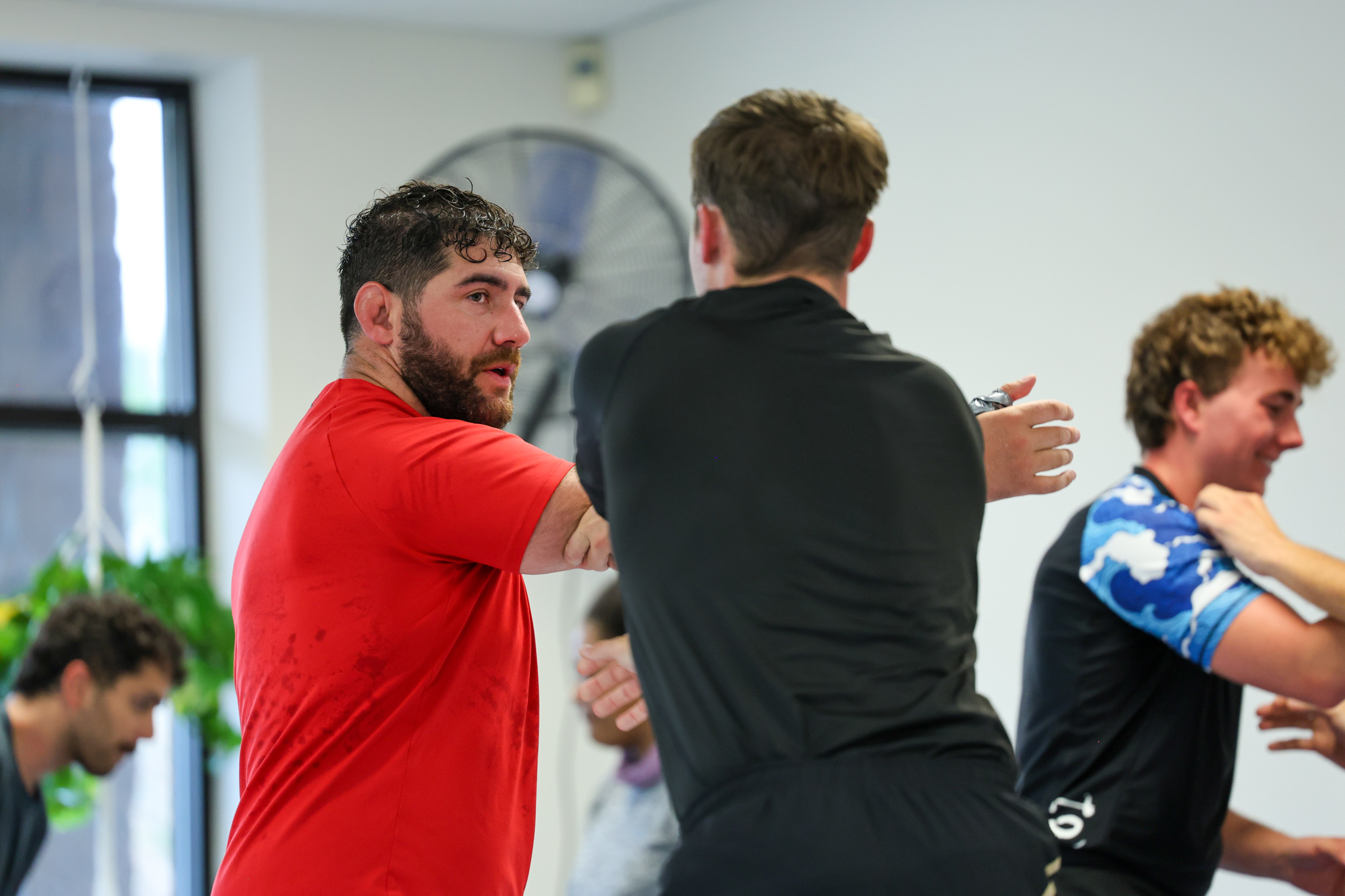 Coach working with a training partner during class at Golden Jiu Jitsu